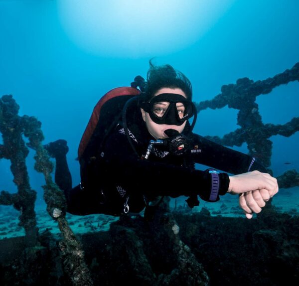 A diver in perfect buoyancy over a wreck.