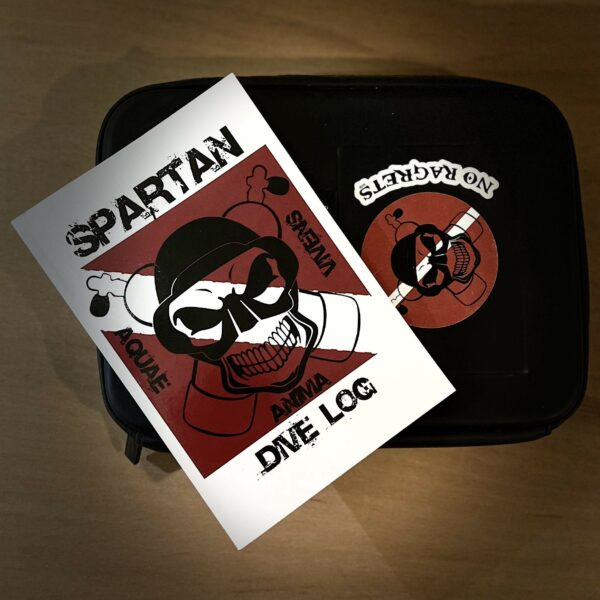 A photo of the Spartan Dive log resting on a water resistant case.