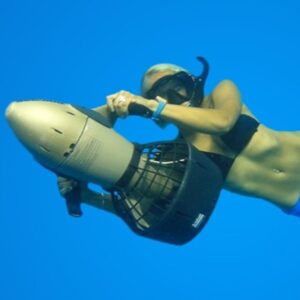 A free diver uses a DPV for efficient propulsion under water.