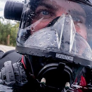 A close up photo of a public safety diver wearing a full face mask.