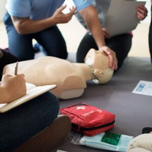 A group of students working with their First Response Instructor to become certified 1st aid, cpr, aed providers in their community.
