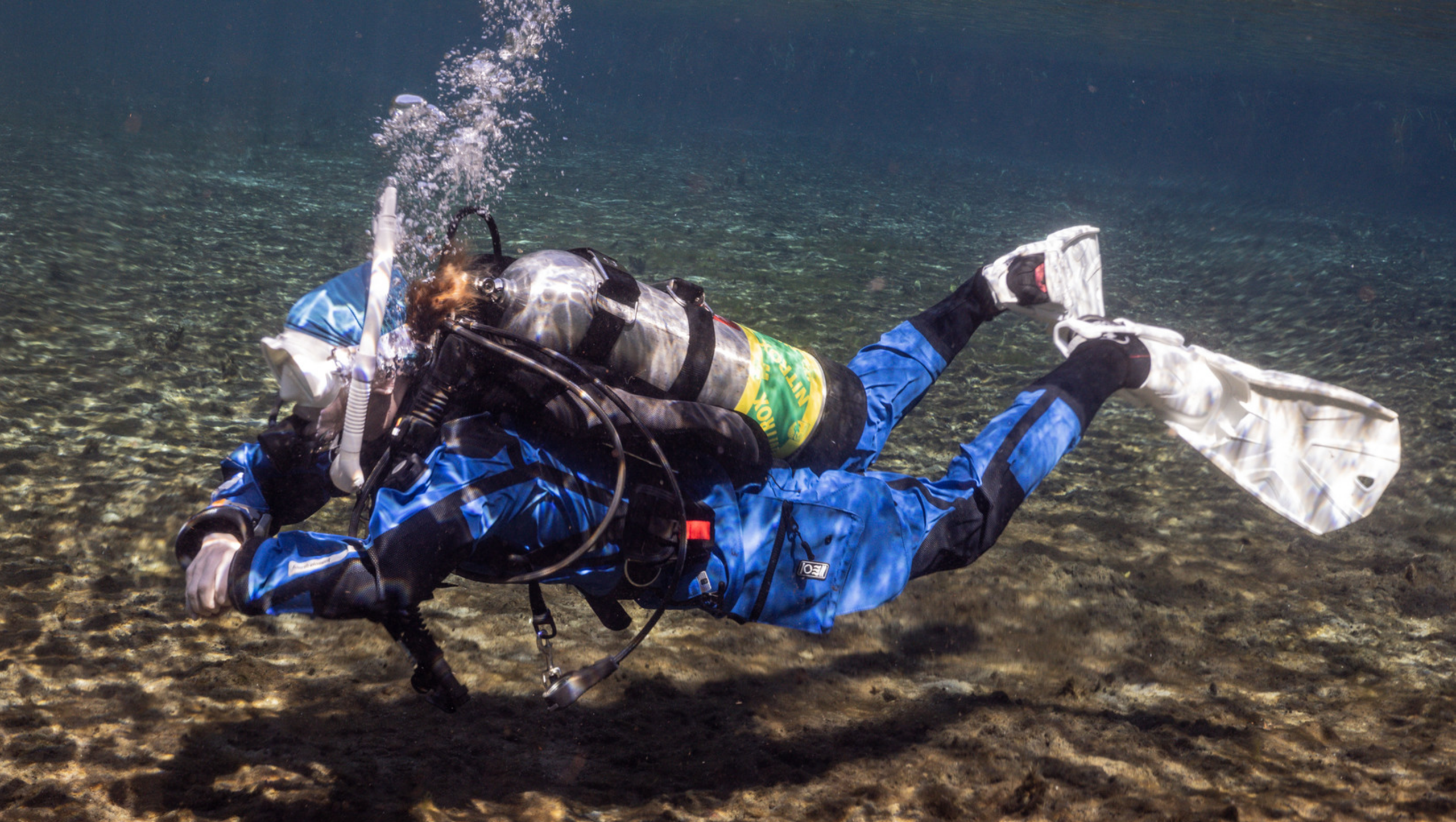 A recreational foundations diver demonstrating excellent trim and buoyancy, hovering inches off the lake bottom without disturbing the sediment.