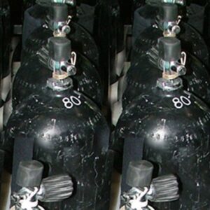 Black and white image of 80cf aluminum cylinders standing in neat rows.